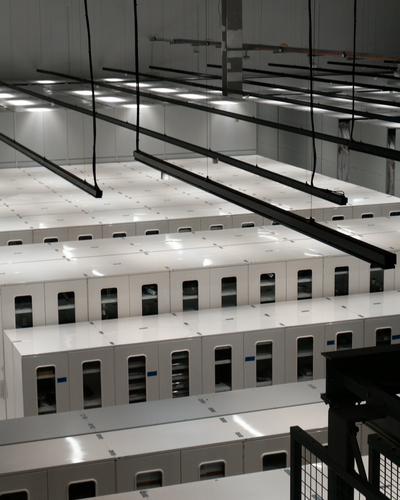 Rows of white server cabinets inside a modern data center